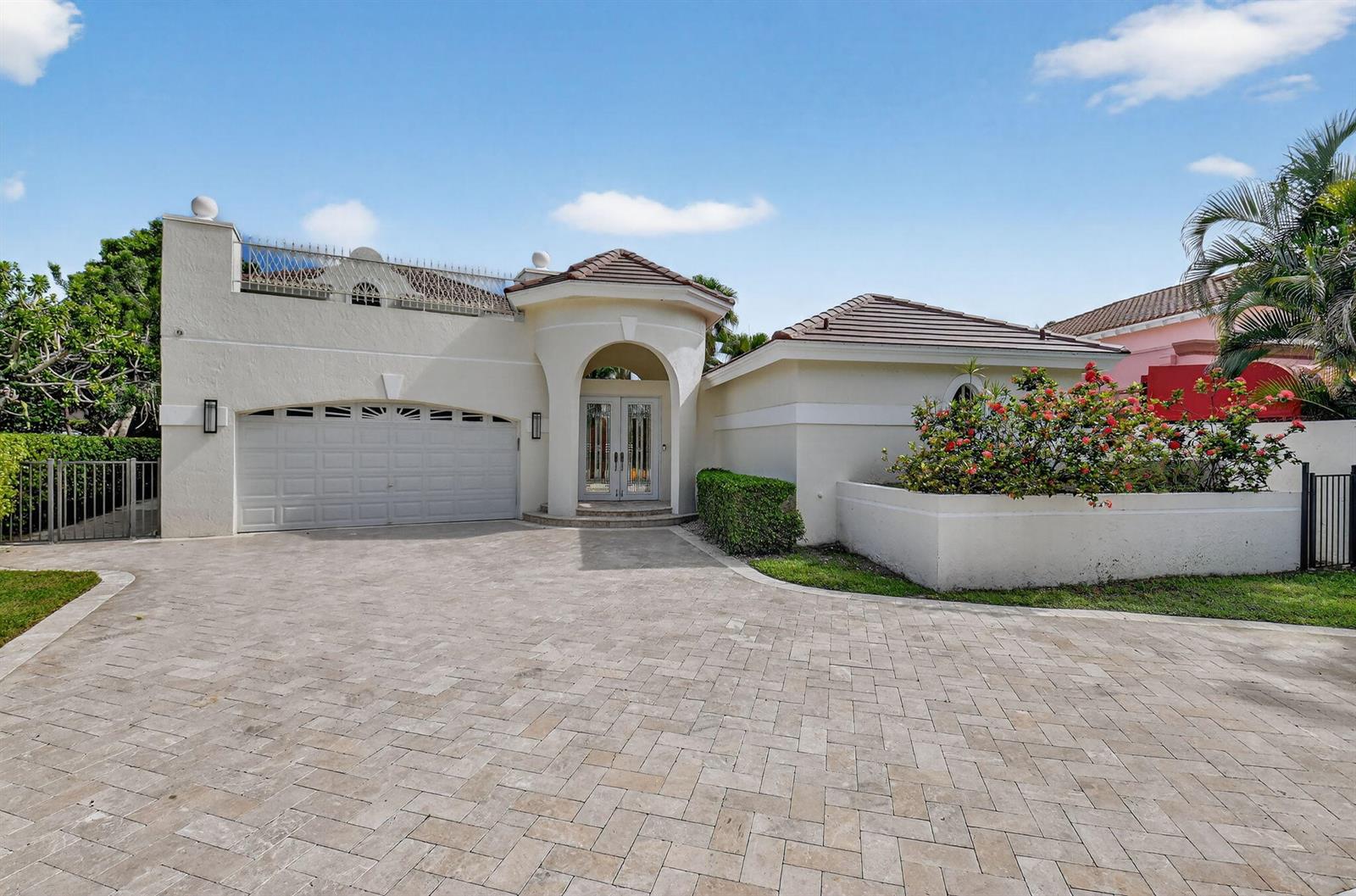 A single-story house with a paved driveway, two-car garage, and a central arched entryway — 16670 Senterra Drive, Delray Beach FL 33484, DELRAY BEACH, FL