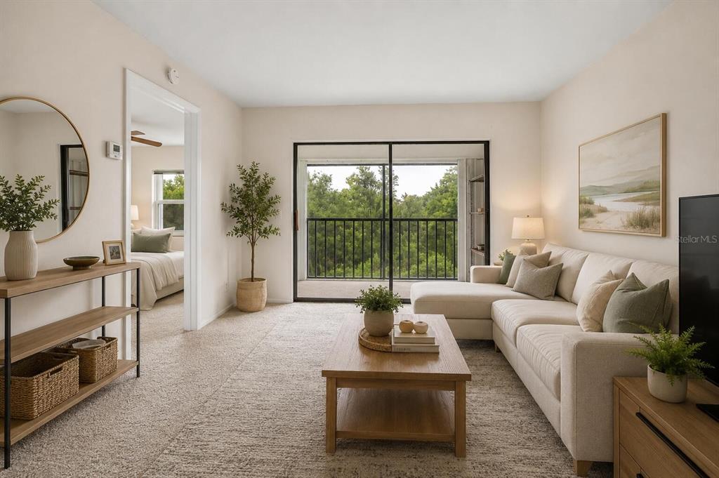 A living room with a beige sectional sofa, wood coffee table, and a sliding glass door — 26485 RAMPART BOULEVARD UNIT A27, PUNTA GORDA, FL