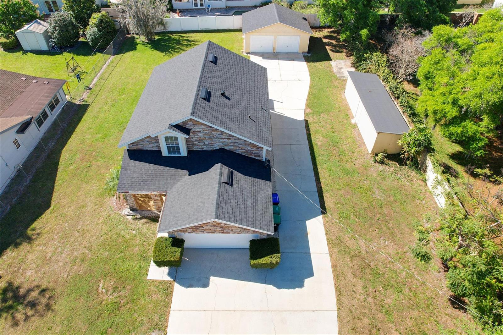An aerial view shows a two-story house with a stone facade, shingled roof, and driveway — 2560 Franklin Avenue, Winter Park FL 32789, WINTER PARK, FL