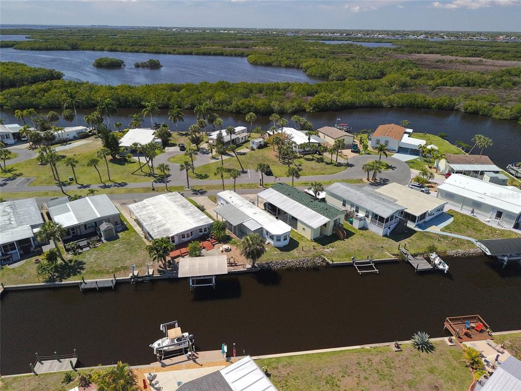An aerial view shows waterfront mobile homes with private docks along a canal — 3300 COQUINA ESPLANADE, PUNTA GORDA, FL