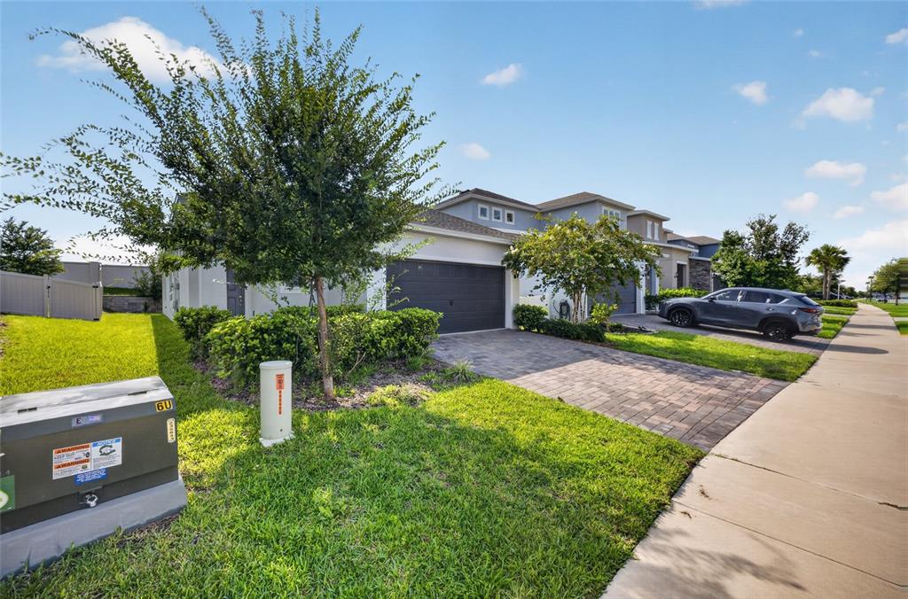 A two-story suburban house with a paved driveway, a gray garage, and a front lawn — 4406 DAVOS DR, CLERMONT, FL