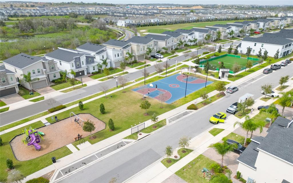 An aerial view of a suburban neighborhood featuring a playground, basketball court, and soccer field — 815 OCEAN COURSE AVENUE UNIT 815, DAVENPORT, FL