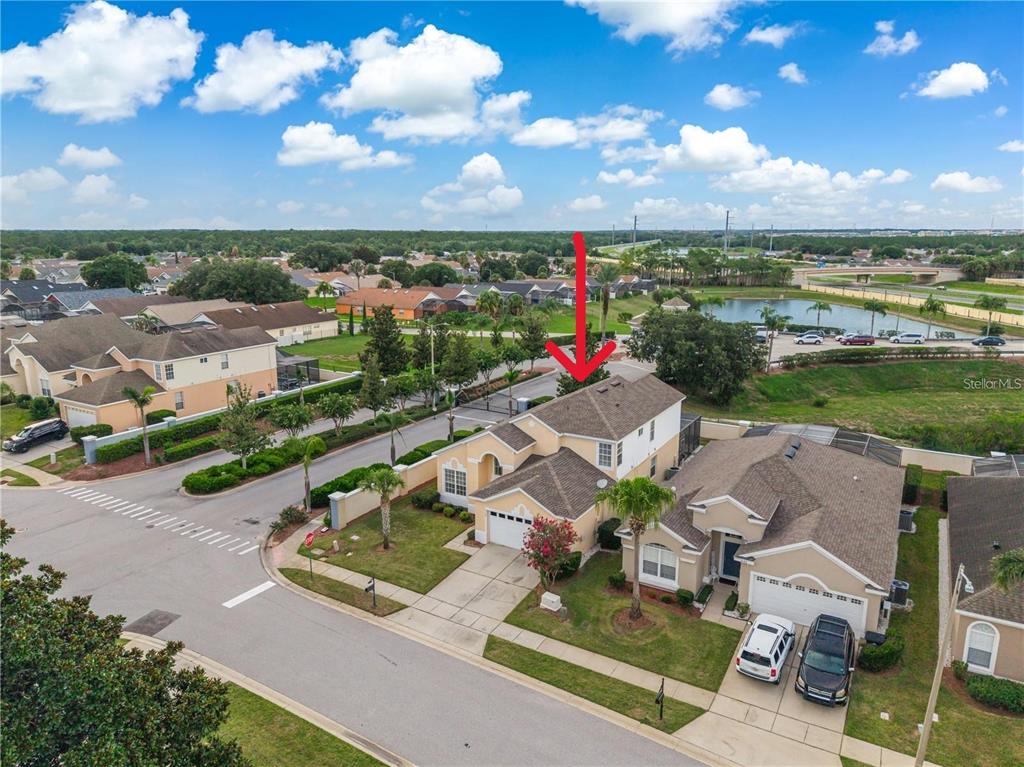 An aerial view shows a suburban house with a two-car garage and a screened pool — 8184 FAN PALM WAY, KISSIMMEE, FL