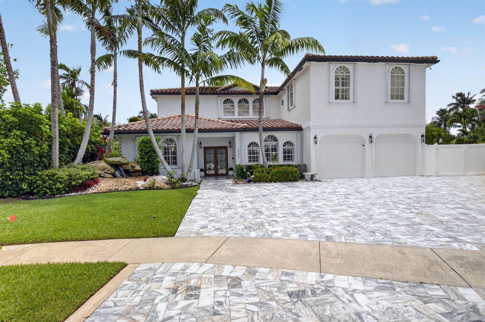 A two-story white house with a tiled roof, palm trees, and a marble-paved driveway — 1502 SW 5th Avenue, Boca Raton FL 33432, BOCA RATON, FL