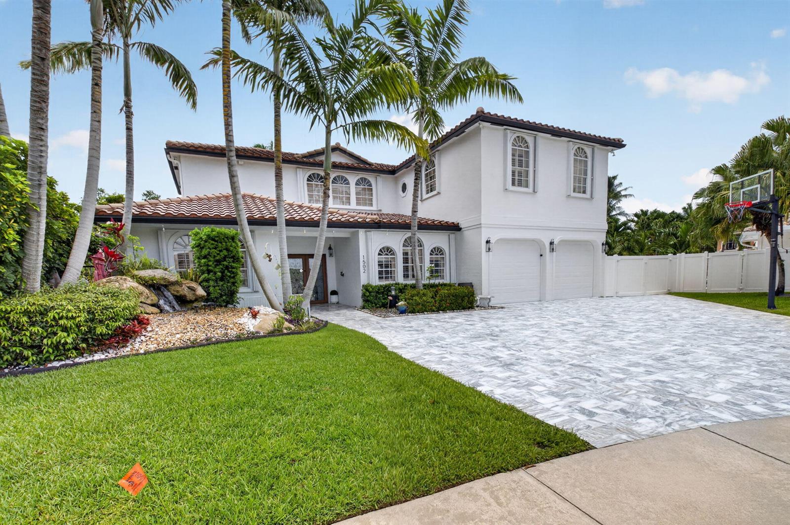 A two-story white house with a tile roof, palm trees, and a paved driveway — 1502 SW 5th Avenue, Boca Raton FL 33432, BOCA RATON, FL