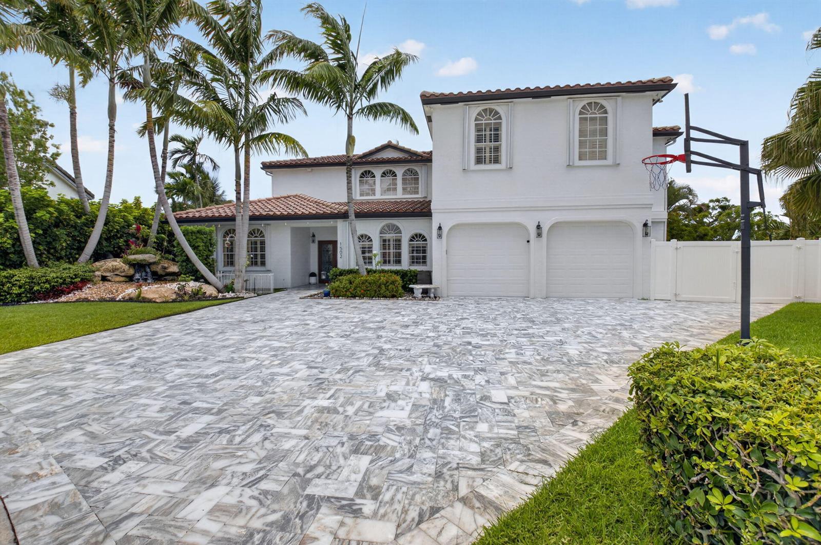 A two-story white house with a tiled roof, palm trees, and a paved driveway — 1502 SW 5th Avenue, Boca Raton FL 33432, BOCA RATON, FL