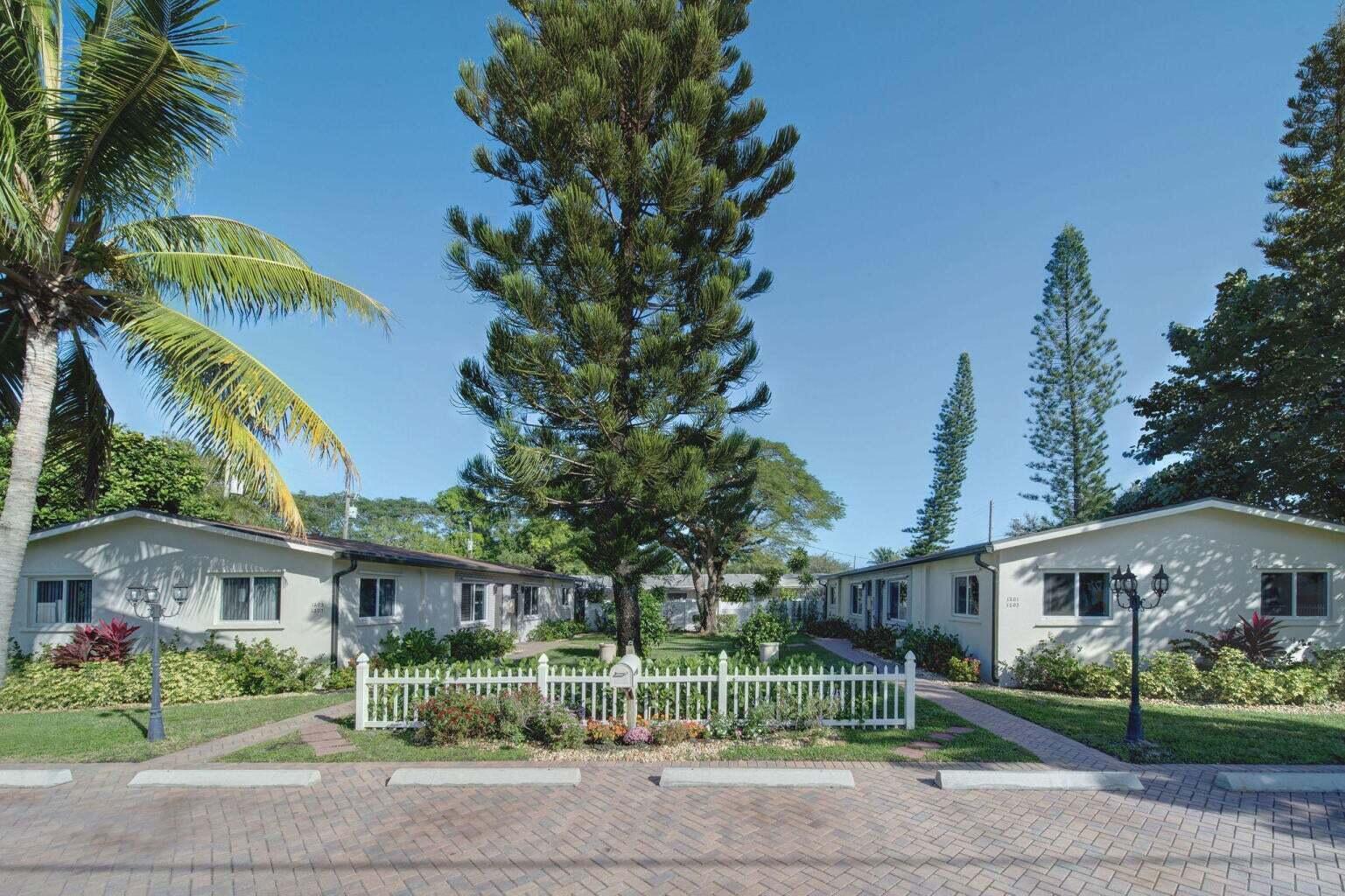 A white picket fence separates a brick parking area from two single-story apartment buildings — 1201 NE 2nd Avenue, Delray Beach FL 33444, DELRAY BEACH, FL