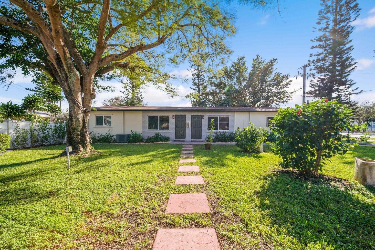 A single-story duplex with a stone path leading to two front doors across a lawn — 1201 NE 2nd Avenue, Delray Beach FL 33444, DELRAY BEACH, FL