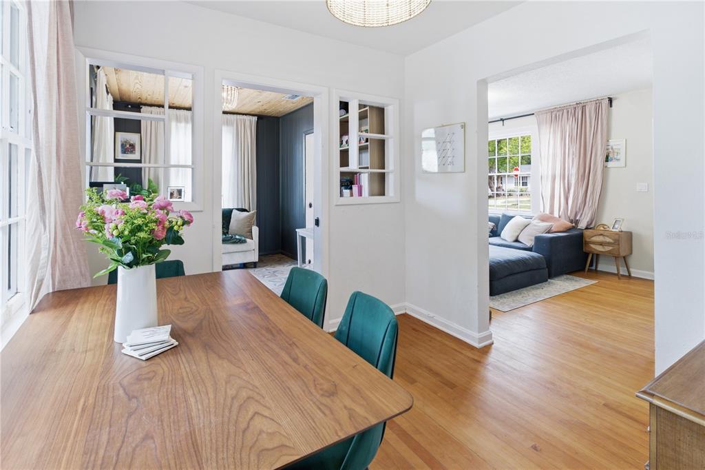 A dining room with a wooden table, green chairs, and views into adjacent living spaces — 4224 REDWOOD AVENUE, JACKSONVILLE, FL