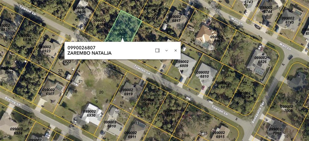 This is a satellite map view showing property parcel boundaries and lot numbers — TOWTON LANE, NORTH PORT, FL