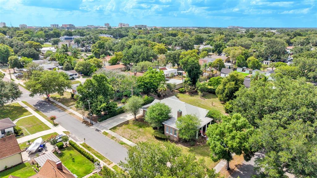 An aerial view shows a single-story brick house with a gray roof in a neighborhood — 747 S CLAYTON AVENUE, LAKELAND, FL