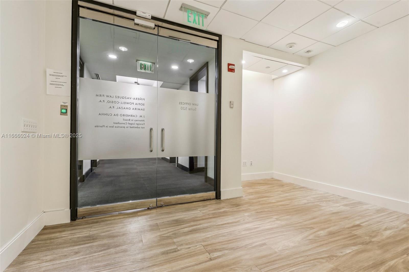A glass double door entrance leads into an office suite with wood-look flooring — 1200 Brickell Ave # D, Miami FL 33131, MIAMI, FL