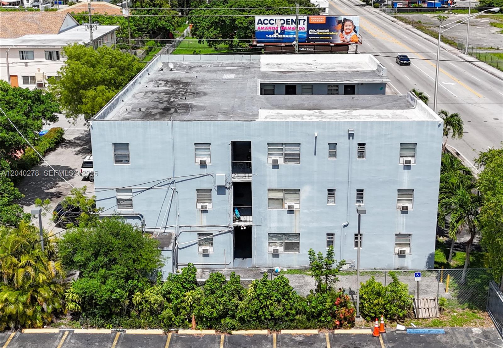 An aerial view shows the exterior of a three-story light blue apartment building — 1801 NW 54th St, Miami FL 33142, MIAMI, FL