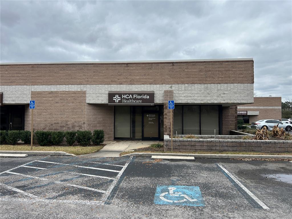 The exterior of a commercial building features an HCA Florida Healthcare sign and parking spaces — 3300 SW 34TH AVENUE UNIT 104 & 108, OCALA, FL