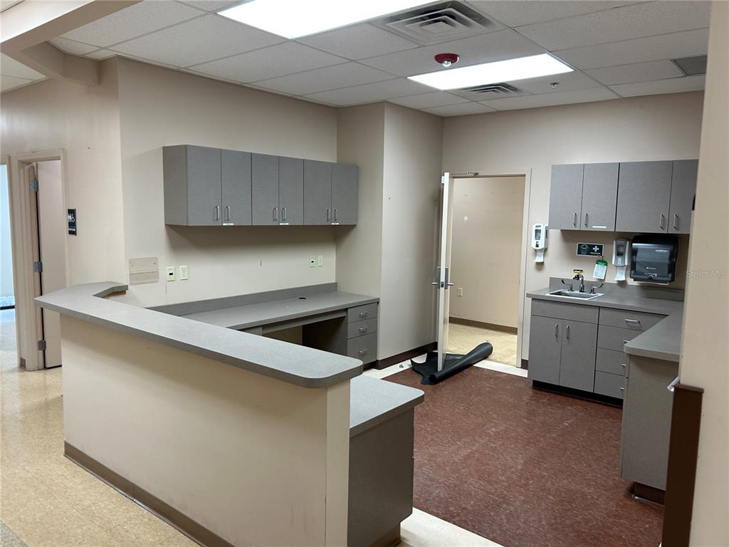 A medical office reception area features gray cabinetry, a laminate countertop, and a sink — 3300 SW 34TH AVENUE UNIT 104 & 108, OCALA, FL