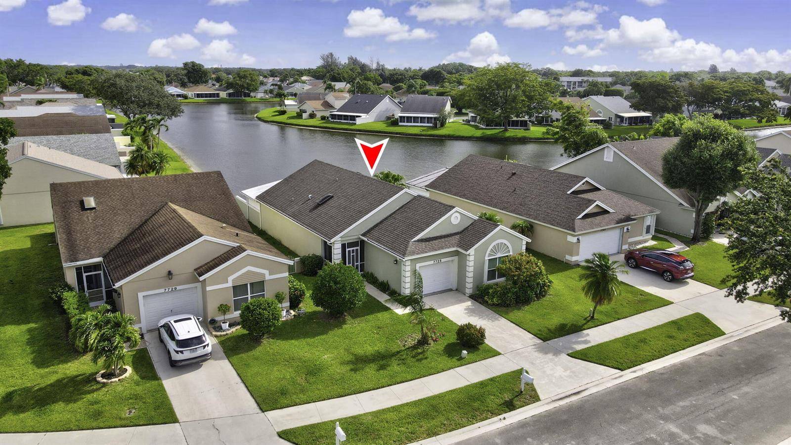 An aerial view shows a suburban house with a red arrow pointing to its roof — 7725 Mansfield Hollow Road, Delray Beach FL 33446, DELRAY BEACH, FL