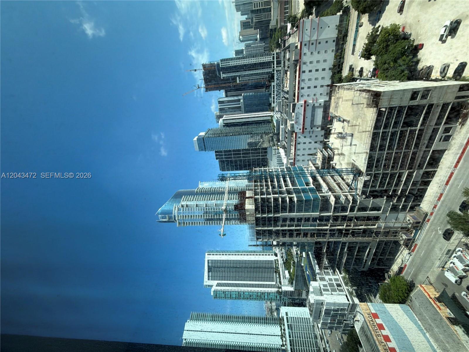 An elevated view shows multiple high-rise buildings and construction sites in a dense urban area — 20 NE 11th St # 2409, Miami FL 33132, MIAMI, FL