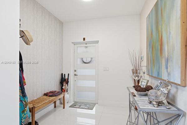 A bright entryway features a white front door, a wooden bench, and a console table — 2931 SW 38th Ct # 2, Miami FL 33134, MIAMI, FL