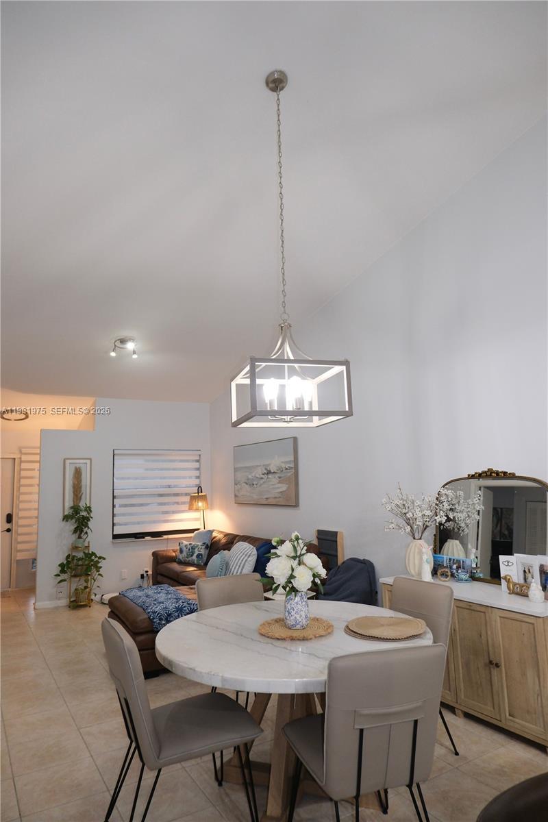 A dining area with a round marble table and a rectangular pendant light fixture — 1021 NW 79th Ave, Plantation FL 33322, PLANTATION, FL