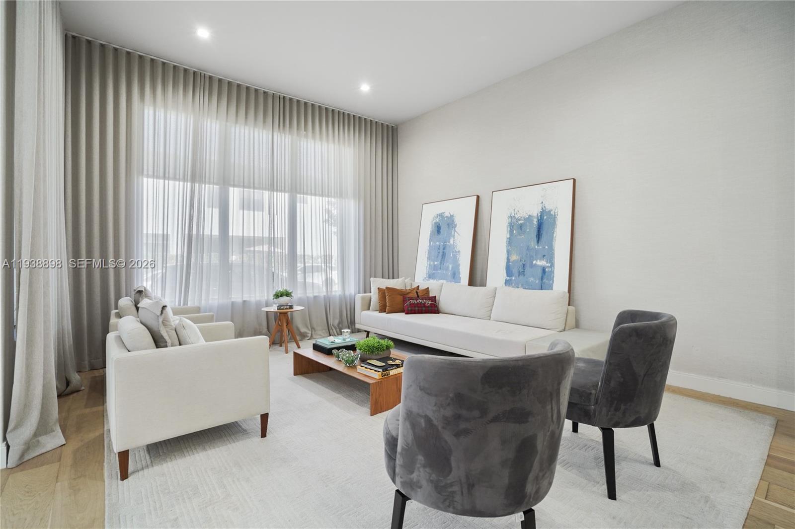 A modern living room features a white sofa, two armchairs, and two grey velvet chairs — 8144 NW 43rd St, Doral FL 33166, DORAL, FL