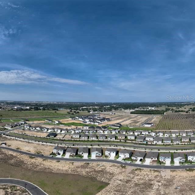 An aerial view shows a suburban neighborhood under construction with rows of houses — 5161 GREEN BELT DRIVE, HAINES CITY, FL