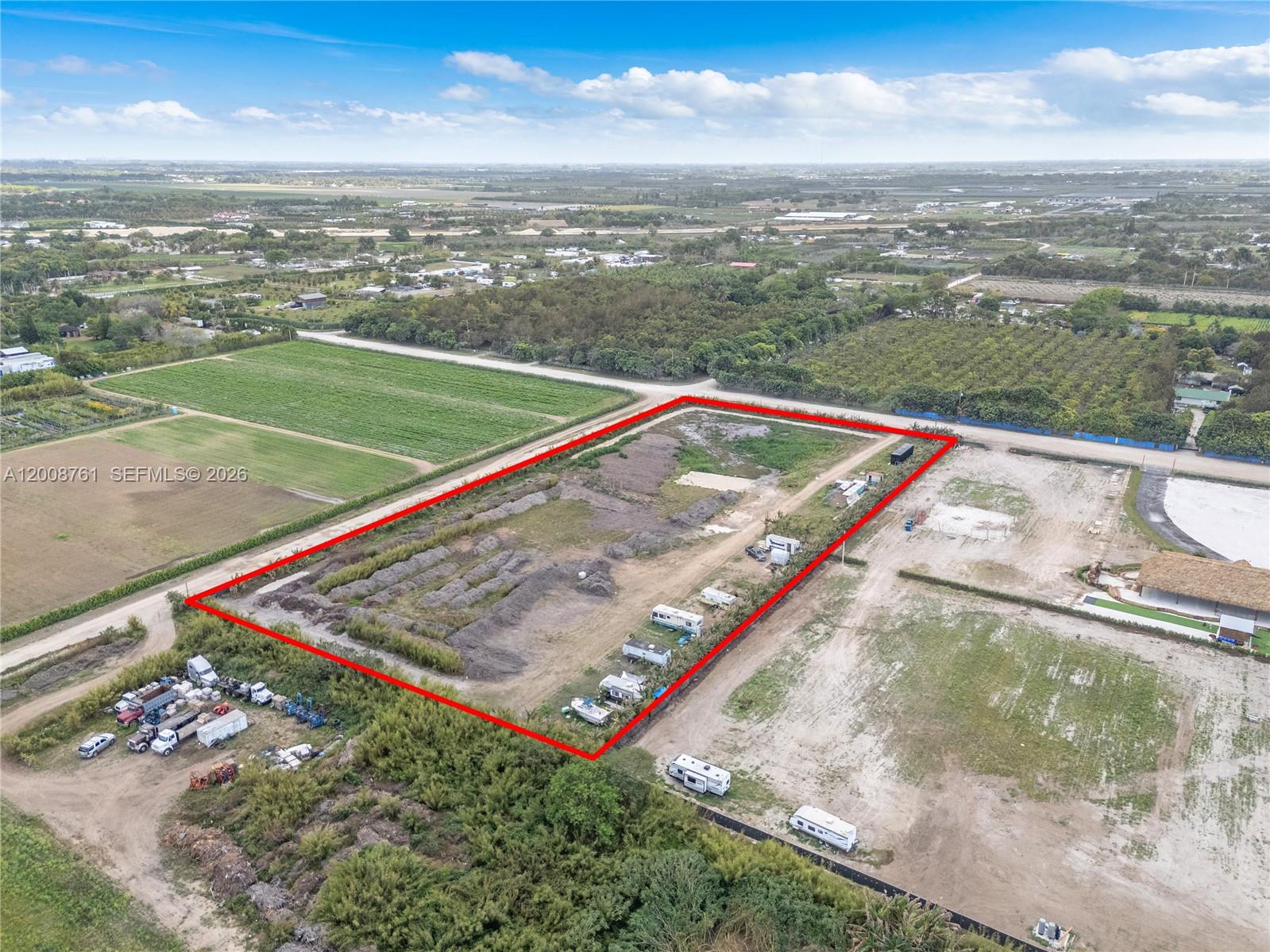 An aerial view shows a rectangular plot of land outlined in red with several trailers — 15202 SW 194th Ave, Miami FL 33196, MIAMI, FL