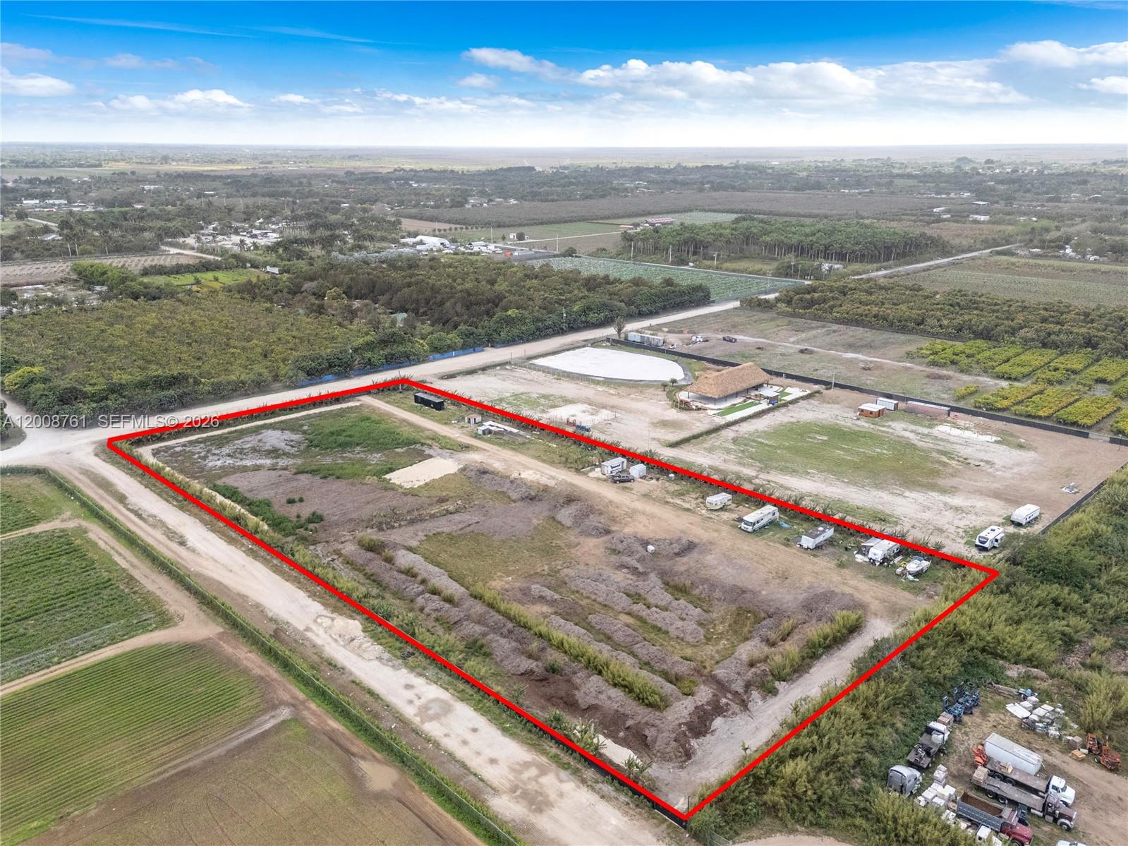 An aerial view shows a large, rectangular plot of vacant land outlined in red — 15202 SW 194th Ave, Miami FL 33196, MIAMI, FL