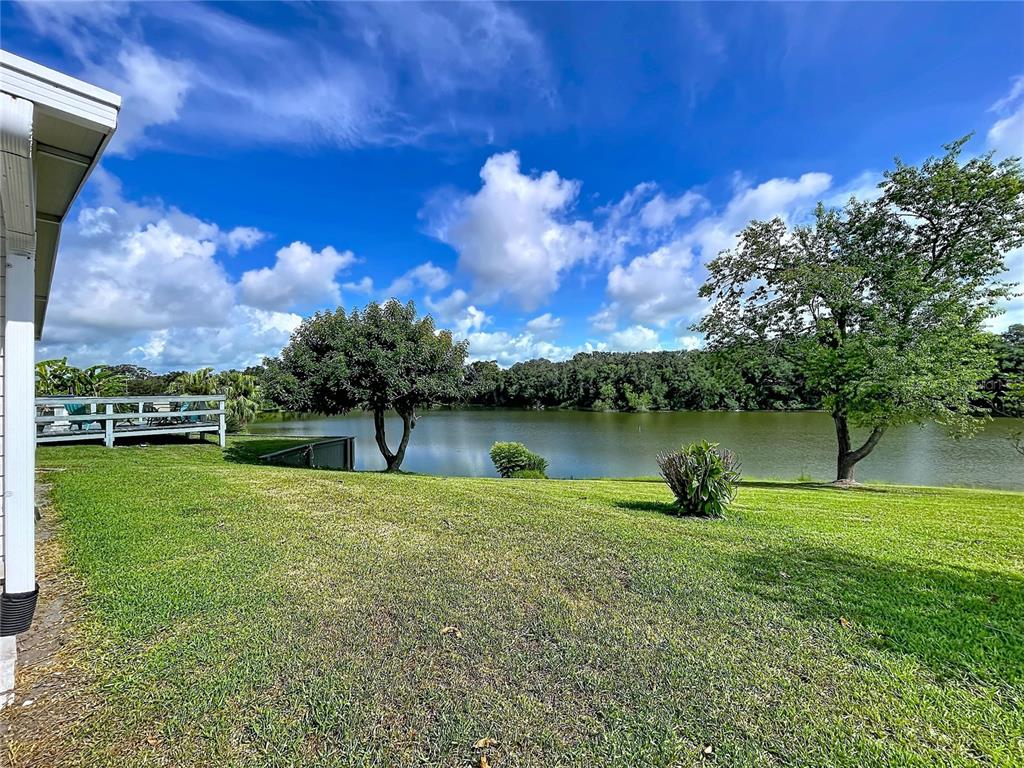 An aerial view of a swimming pool surrounded by a patio, lounge chairs, and trees — 2055 S FLORAL AVENUE UNIT 192, BARTOW, FL