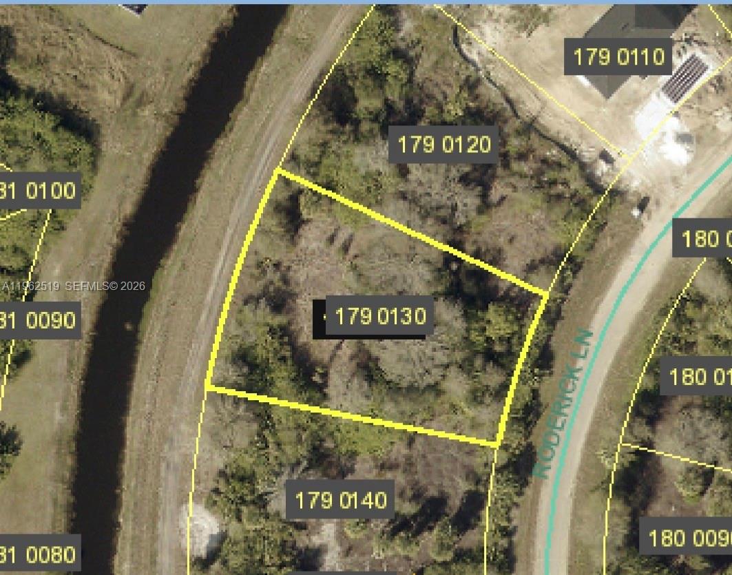 This is an aerial map showing a vacant lot outlined in yellow — 1913 Roderick Ln, Lehigh Acres FL 33972, LEHIGH ACRES, FL
