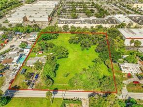 An aerial view shows a large, rectangular grassy lot outlined in red near commercial buildings — 1865 Donnell Road, West Palm Beach FL 33409, WEST PALM BEACH, FL