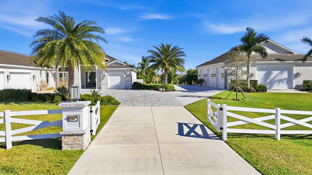 A paved driveway leads to a house and a separate garage building with palm trees — 3467 COMPOUND COURT, SARASOTA, FL