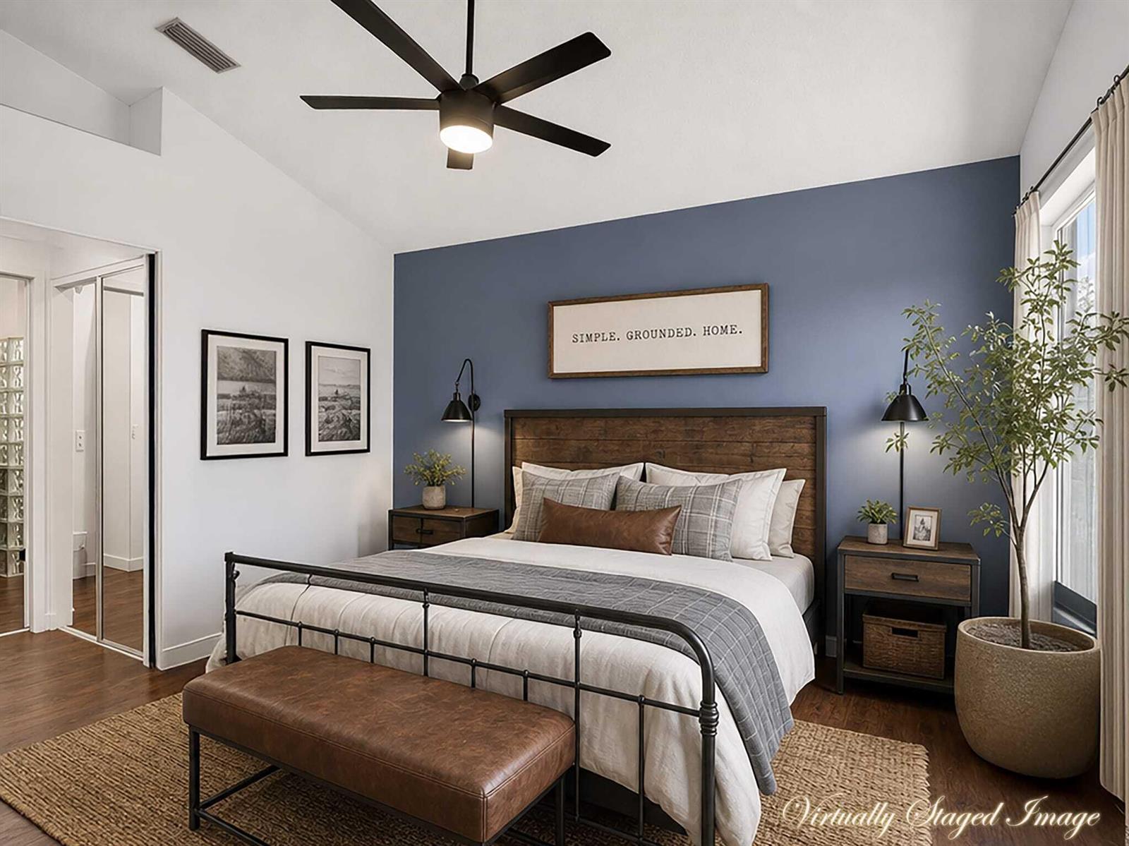 A bedroom features a blue accent wall, a metal bed frame, and a ceiling fan — 7550 Ironbridge Circle, Delray Beach FL 33446, DELRAY BEACH, FL