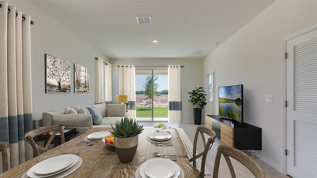 A bedroom features a bed, dresser, floor mirror, armchair, and an attached bathroom doorway — 4603 SW 71ST LANE ROAD, OCALA, FL