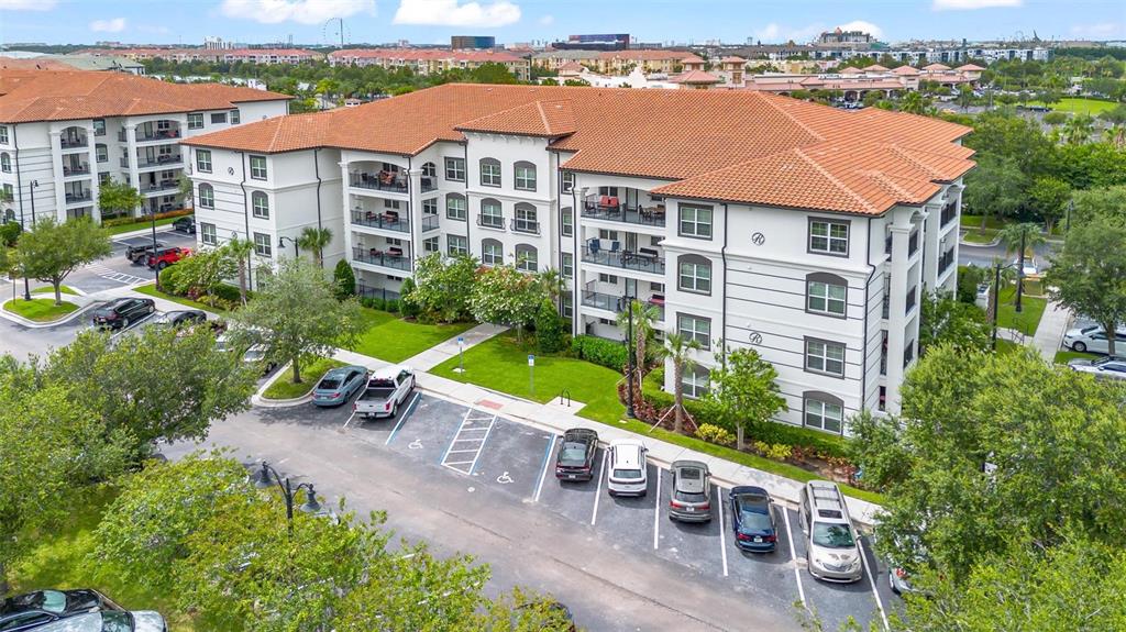 An aerial view of a multi-story apartment building with a tiled roof and parking lot — 4001 BREAKVIEW DRIVE UNIT D409, ORLANDO, FL