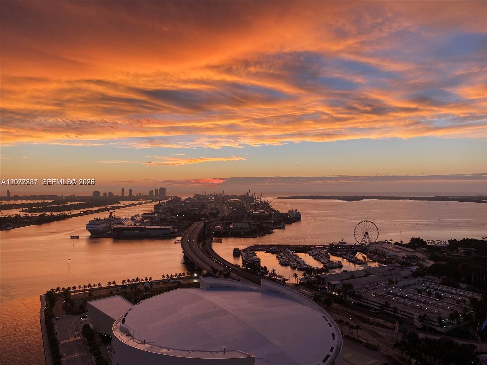 An aerial view shows a bridge, a cruise ship, a marina, and a Ferris wheel — 888 Biscayne Blvd # 3001, Miami FL 33132, MIAMI, FL