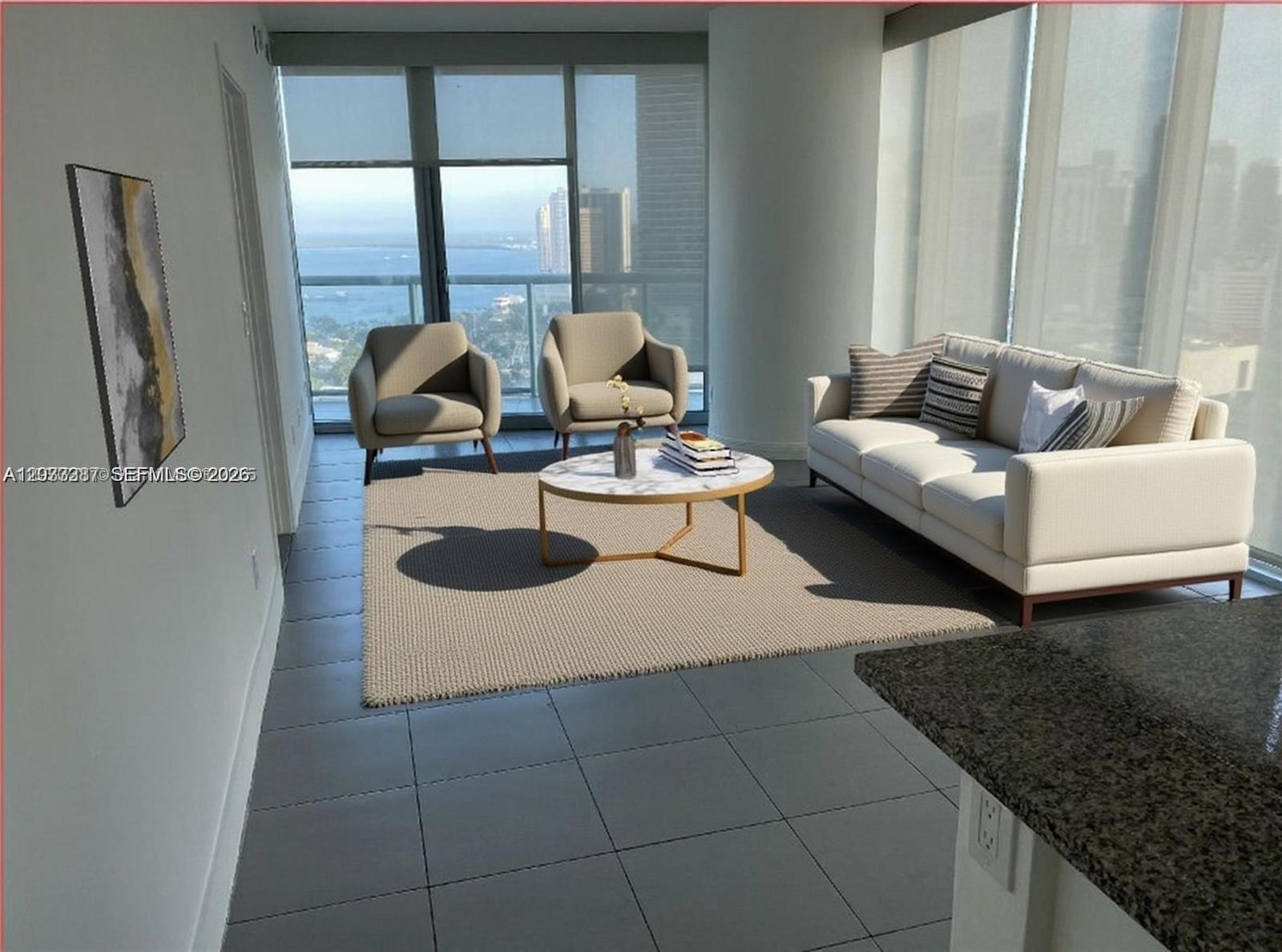 A modern living room features a sofa, two armchairs, a coffee table, and floor-to-ceiling windows — 888 Biscayne Blvd # 3001, Miami FL 33132, MIAMI, FL