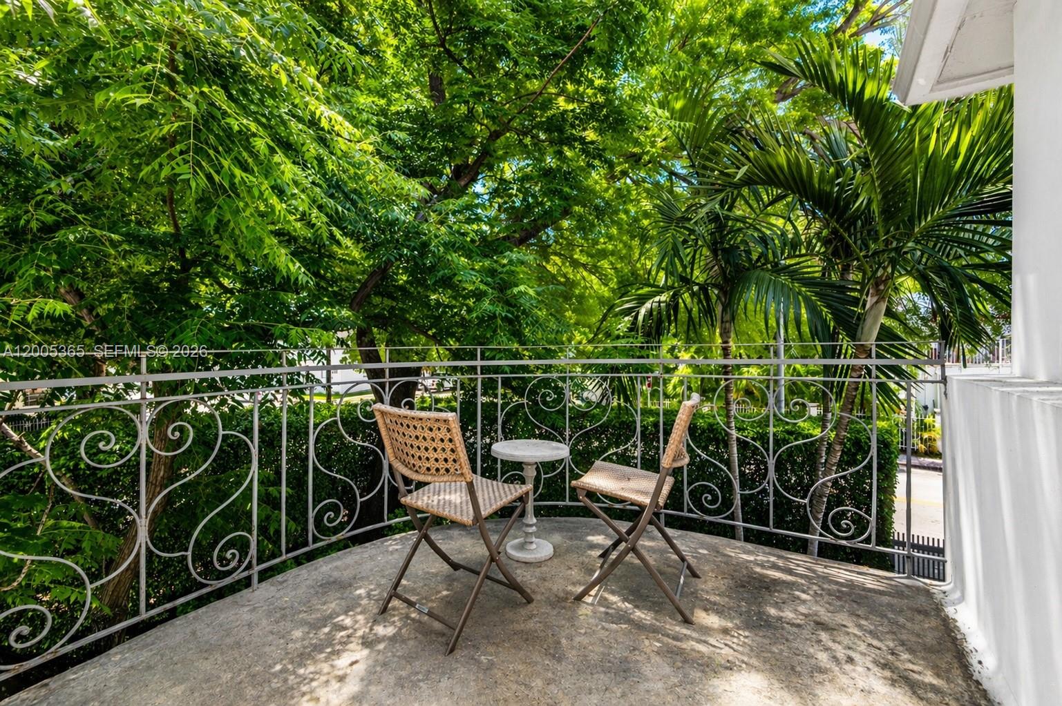 A small balcony features two wicker chairs, a round table, and decorative metal railings — 1005 9th St # 2, Miami Beach FL 33139, MIAMI BEACH, FL