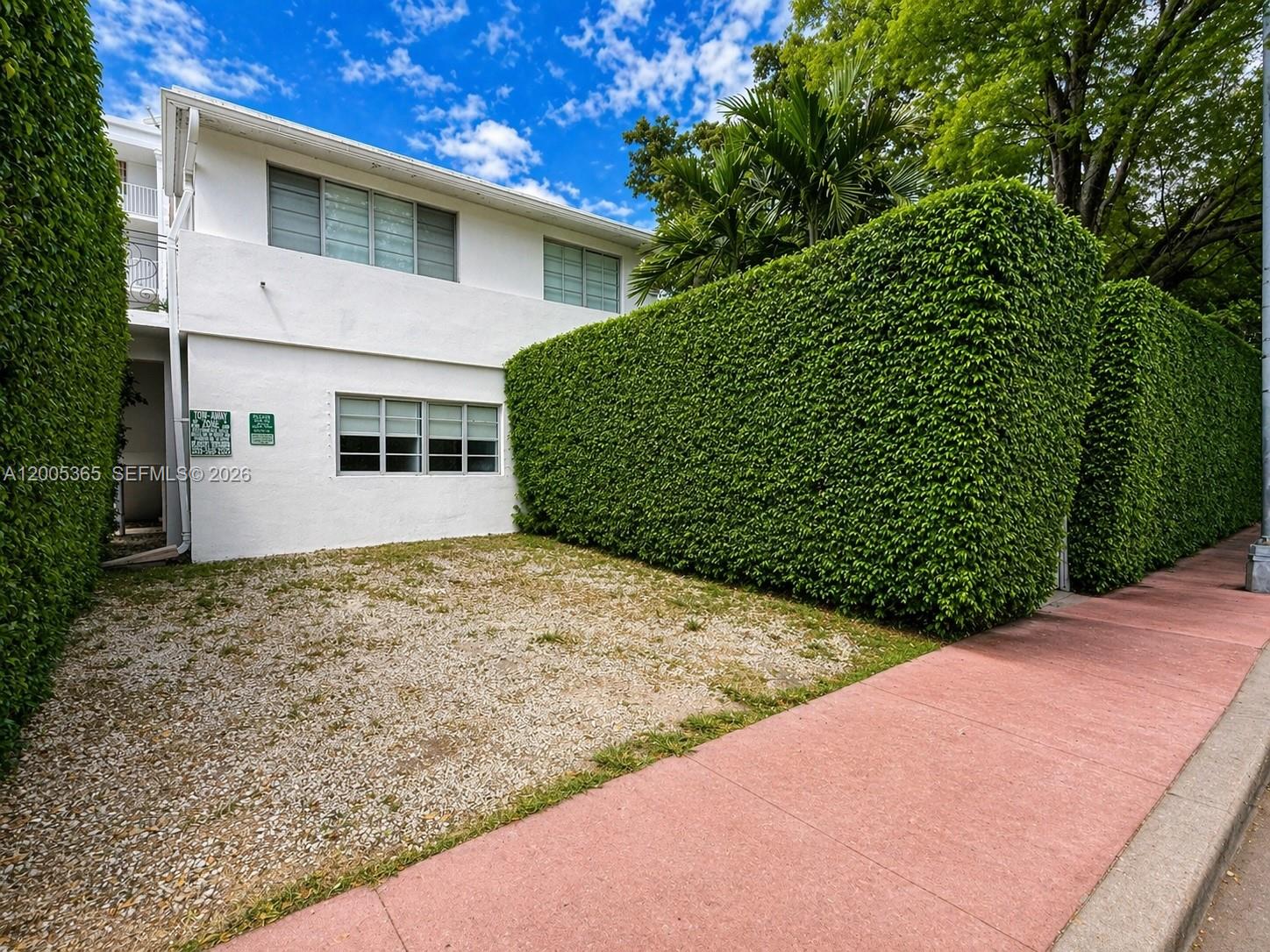 A two-story white building features a gravel parking area and a tall, manicured green hedge — 1005 9th St # 2, Miami Beach FL 33139, MIAMI BEACH, FL