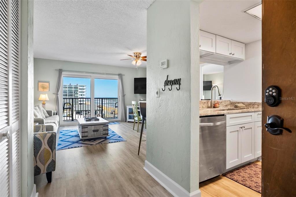 A view from an entryway into a living room and kitchen with ocean views — 3600 S OCEAN SHORE BOULEVARD UNIT 614, FLAGLER BEACH, FL