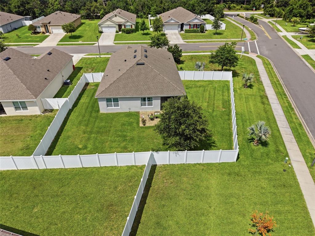 An aerial view shows a suburban house with a fenced backyard and a corner lot — 117 RIP CORD LANE, DELAND, FL