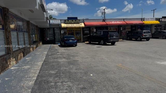 A commercial strip mall with a parking lot and several storefronts under a blue sky — 4021 NW 7th St # 5, Miami FL 33126, MIAMI, FL