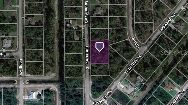 This is an aerial map view showing a vacant rectangular lot highlighted in purple — 323 BUTLER AVENUE S, LEHIGH ACRES, FL