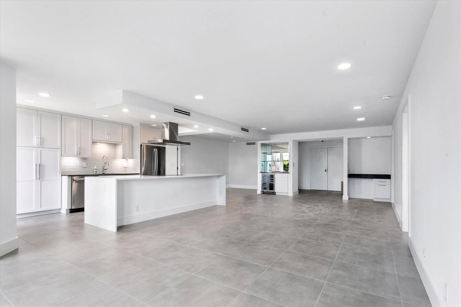 A bedroom with a white desk, a bed, and sliding glass doors opening to a balcony — 2778 S Ocean Boulevard # 203s, Palm Beach FL 33480, PALM BEACH, FL