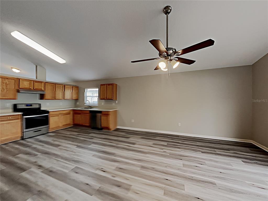 A kitchen with light wood cabinets, stainless steel appliances, and gray wood-look flooring — 3053 EGRETS LANDING DRIVE, LAKE MARY, FL