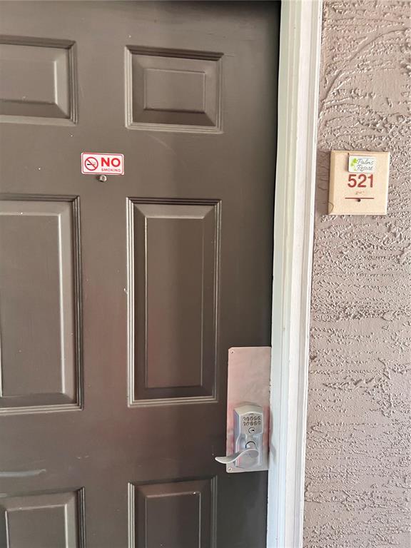 A brown door with a keypad lock and a room number sign labeled 521 — 3100 PARKWAY BOULEVARD UNIT 521, KISSIMMEE, FL