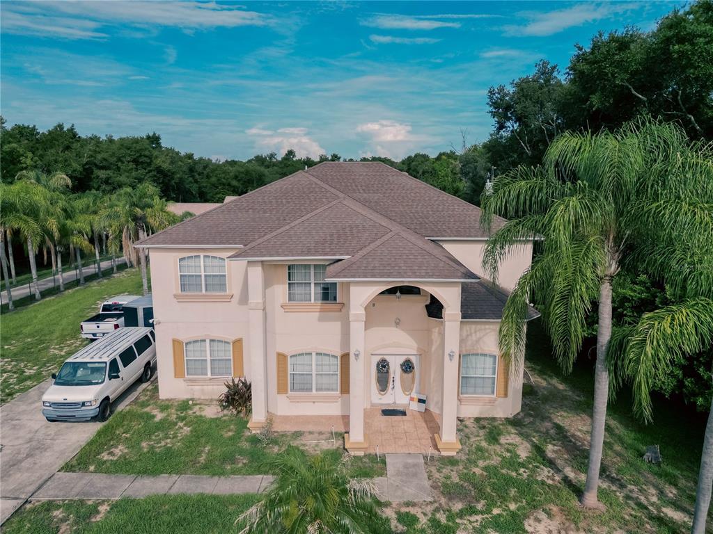 An aerial view of a two-story beige house with a brown roof and palm trees — 2266 RED GATE ROAD, ORLANDO, FL