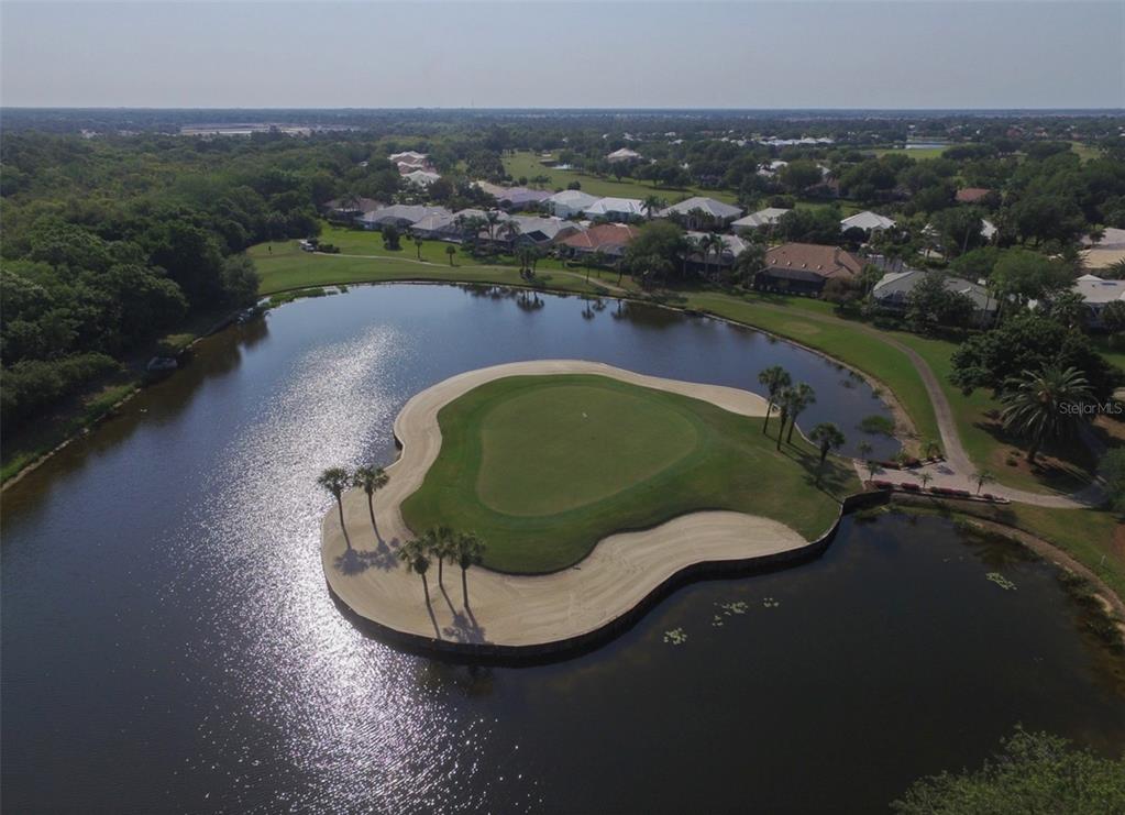 An aerial view of an island golf green surrounded by a water hazard and sand bunkers — 226 SOUTHAMPTON LANE UNIT 257, VENICE, FL