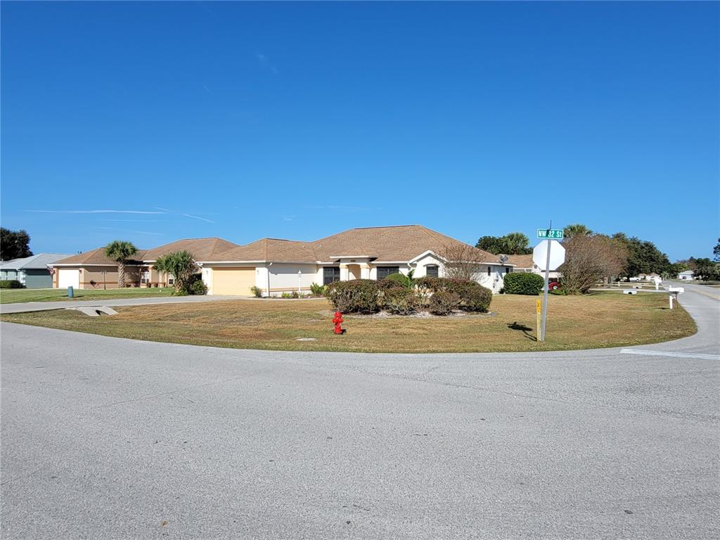 A single-story suburban house with a tan exterior and a brown shingled roof — 4773 NW 32ND STREET, OCALA, FL
