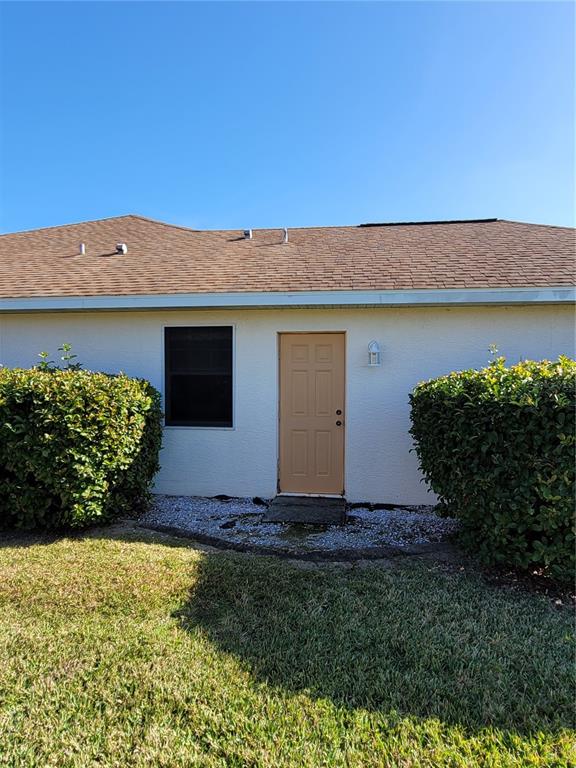 A tan door and a window are centered on the exterior wall of a house — 4773 NW 32ND STREET, OCALA, FL