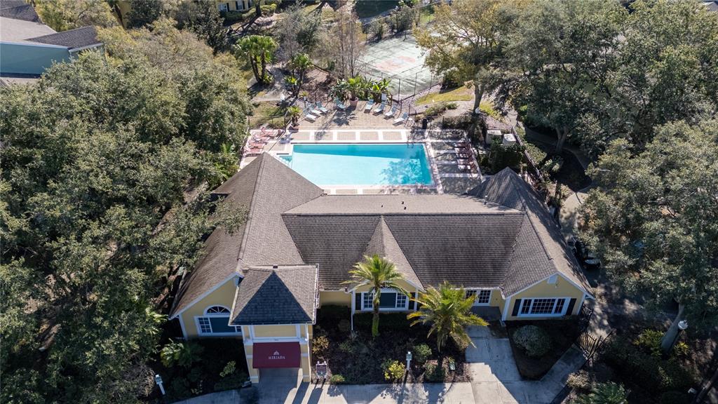 An aerial view shows a yellow clubhouse with a swimming pool and a tennis court — 2077 DIXIE BELLE DRIVE UNIT 2077C, ORLANDO, FL